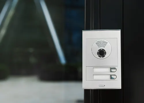 Video intercom system being tested on a residential building wall.
