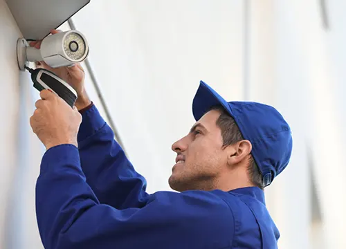Technician setting up advanced tech equipment with precision tools.