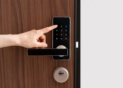 Technician wiring a smart lock system with a maglock mechanism.