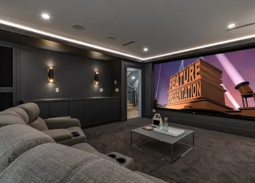 Flat-screen TV and surround speakers setup in a stylish living room.